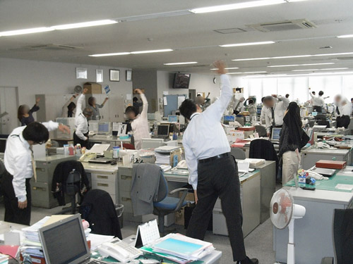 Morning meeting stretches in a Japanese office.